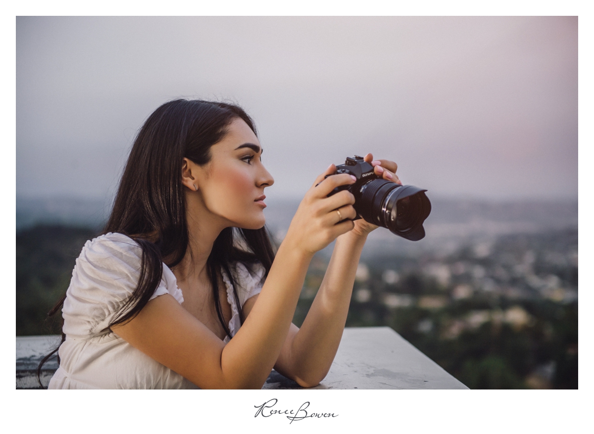 girl with camera overlooking Los Angeles